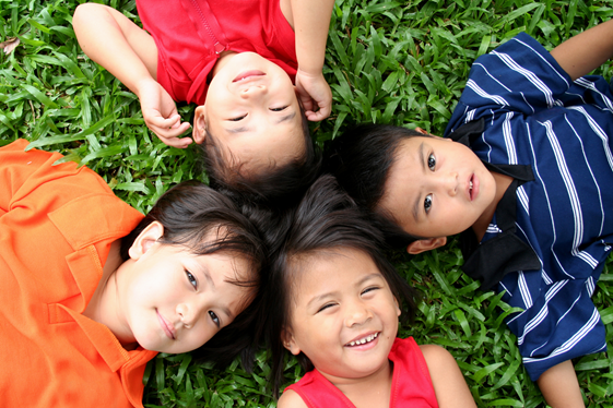 Kids laying on the grass